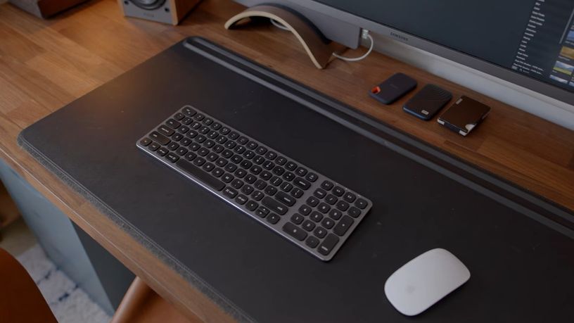 dark desk pad with peripherals on top