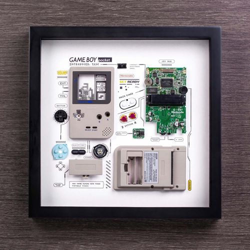 Framed game boy that's been taken apart.